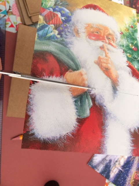 Santa Christmas card being cut to size