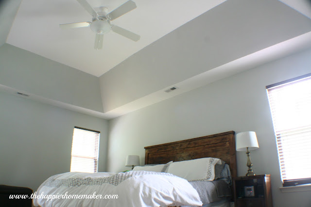 A master bedroom with tray ceiling and Benjamin Moore Alaskan Husky wall paint