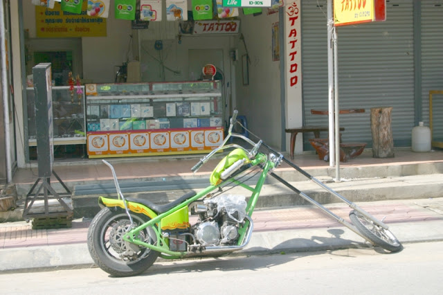 Green Chopper outside of tattoo parlor in Kanchanburi