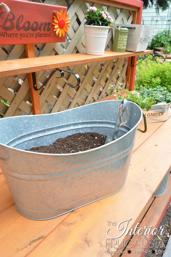 This simple DIY Gardener's Potting Bench can be built in an afternoon with 2x4s. A potting table by day and outdoor bar with solar lights at night.