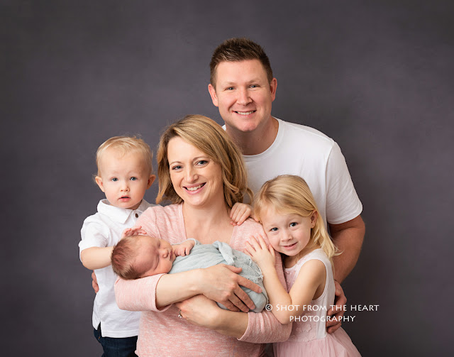 posing family with newborn photography