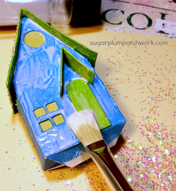 Apply glue to card board putz house