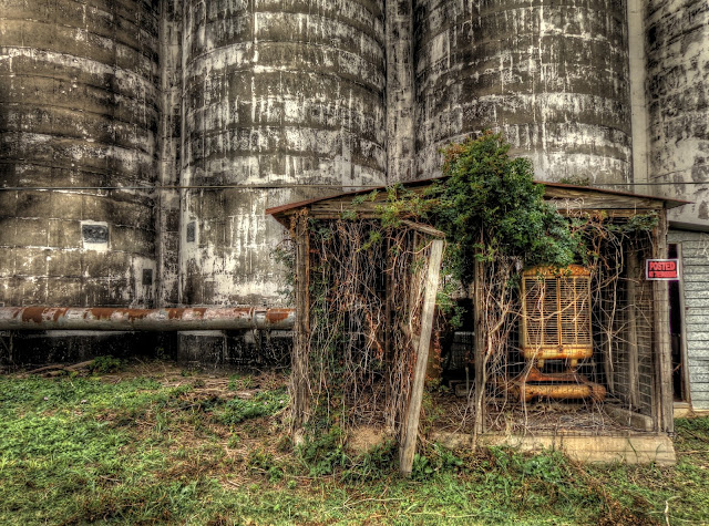 HDR (high dynamic range) photo of a machinery shed in front of a disused silo complex in Katy, Texas. - HDR