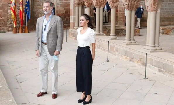 Queen Letizia wore a new puff sleeve sweater by Massimo Dutti. Castaner Carina ankle tie wedge sandals, Emporio Armani trousers