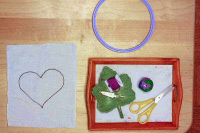 Montessori 'stitching prepared shapes, introducing a hoop' activity tray for children