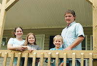 Gibson husband, wife and two children in their new home