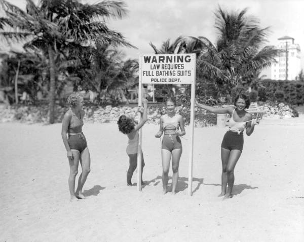 Young Women  Making Fun  of Sign at Beach  Miami Florida 