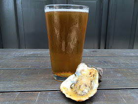 A pint of Gnarly Barley Brewing's Catahoula Common with a chargrilled oyster at Jolie Pearl Oyster Bar in Baton Rouge
