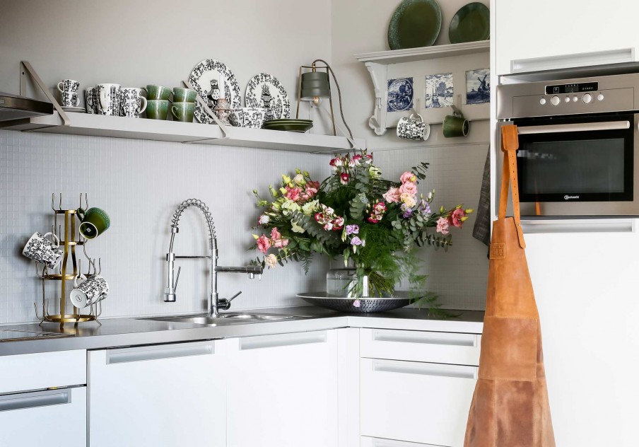 kitchen with botanical decor and flowers and green accents