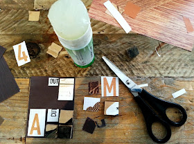A selection of pieces of paper, scissors and a glue stick arranged on a table top.