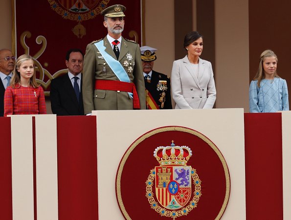 Queen Letizia wore Felipe Varela coat and dress. Crown Princess Leonor and Infanta Sofia attended National Day 2018 parade held at Plaza de Lima