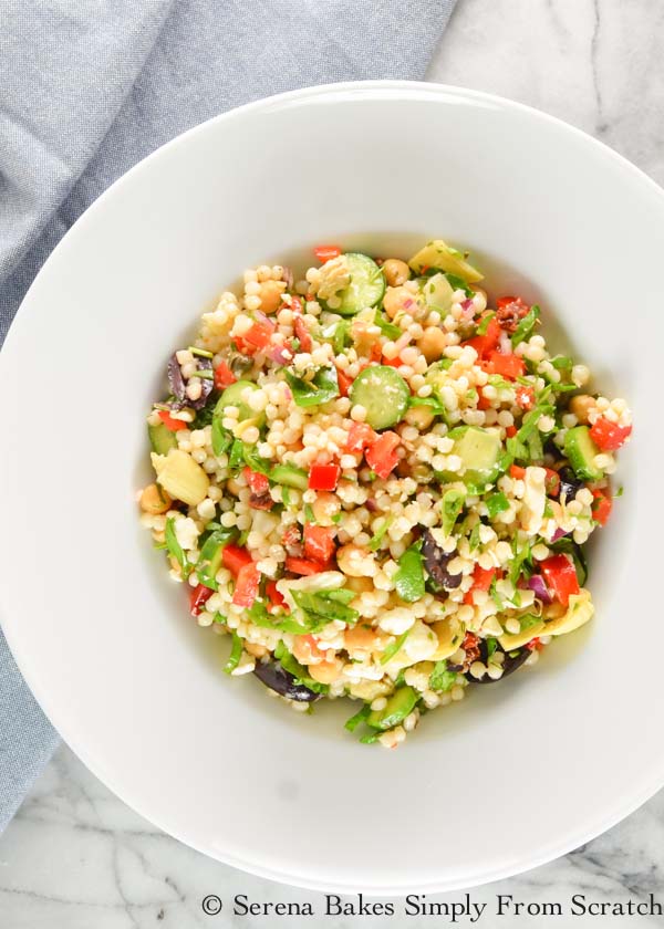 Mediterranean Couscous Pasta Salad is a simple side dish recipe or light dinner with fresh herbs, olives, artichokes, bell pepper, spinach, and lots of other goodies from Serena Bakes Simply From Scratch.