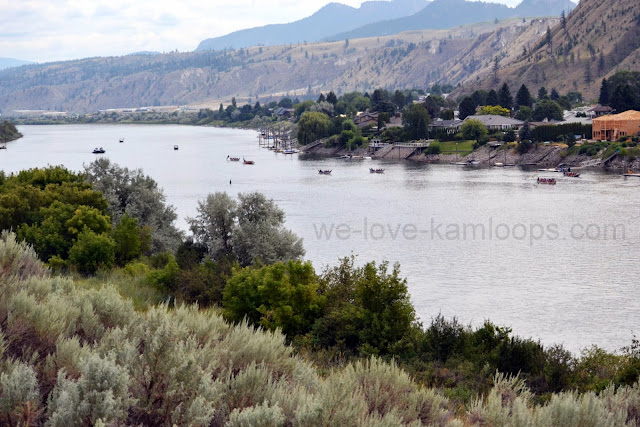 Several canoes can be seen making their way down the river