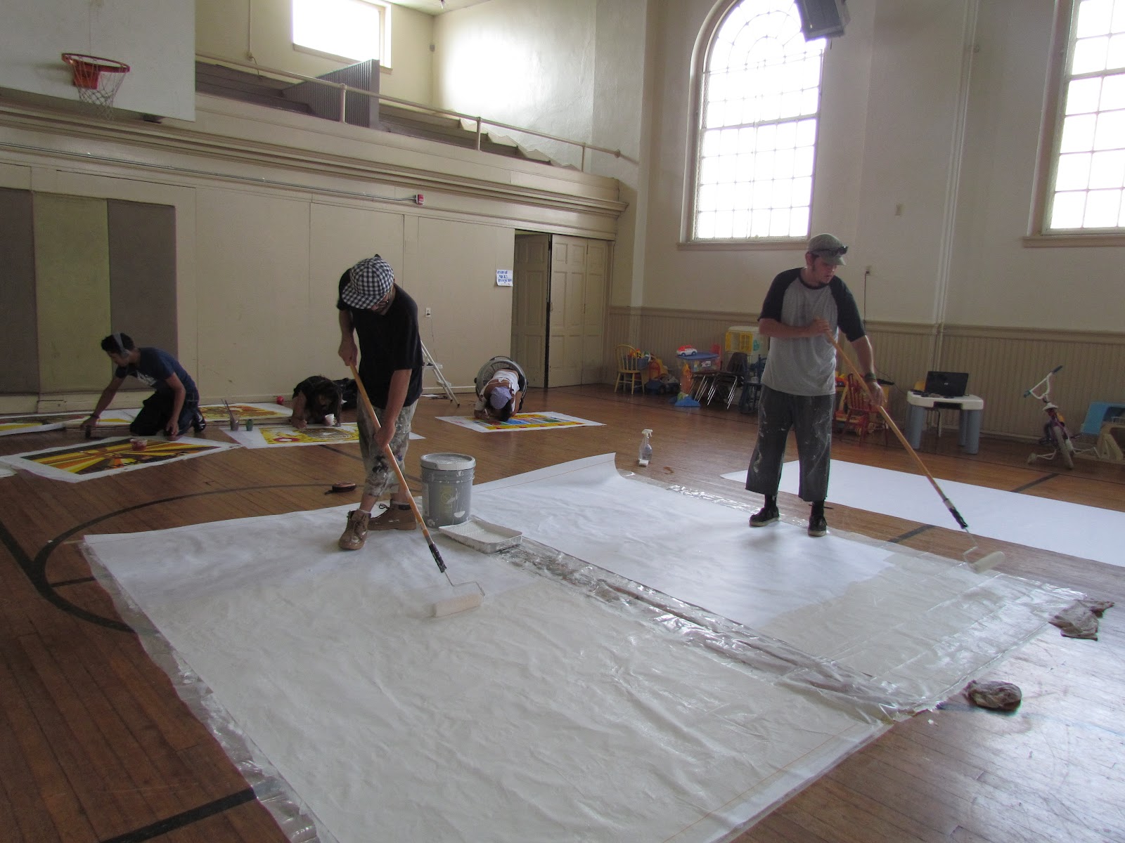 Aqui y Alla Mural Project Day 3 Parachute cloth priming