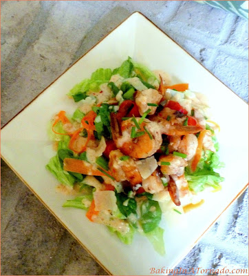 Layered Thai Shrimp Salad uses leftover Thai marinated shrimp, mixed with cool crisp vegetables topped with a parmesan dressing for a flavorful summer meal. | Recipe developed by www.BakingInATornado.com | #recipe #shrimp #dinner
