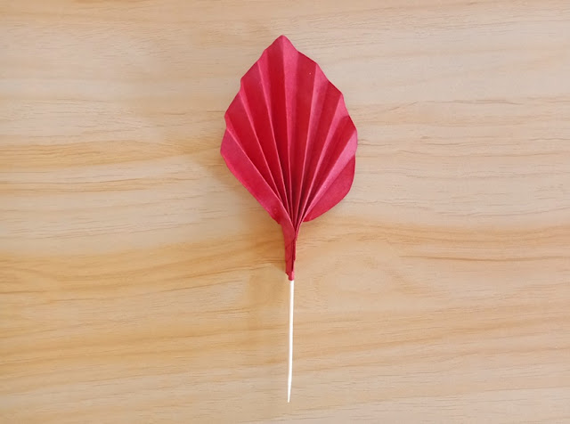 single red palm leaf made of paper