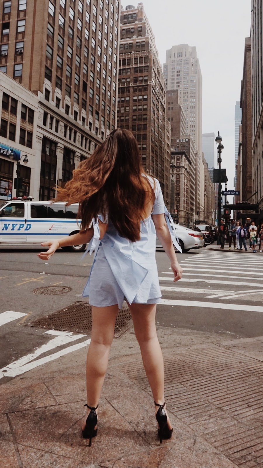 Stewart Hotel NYC girl standing on NYC street corner of New York