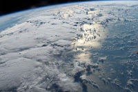 Clouds and Sun's reflection on Pacific Ocean seen from the International Space Station