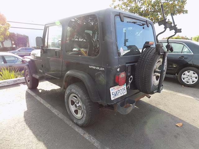 Faded Jeep Wrangler before repainting at Almost Everything Auto Body.