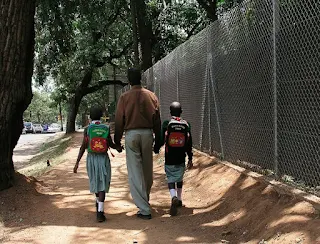 A father and his children in Mukono Uganda.