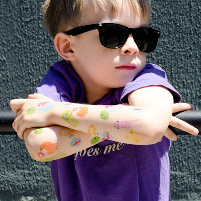 young boy with monster-themed temporary tattoos