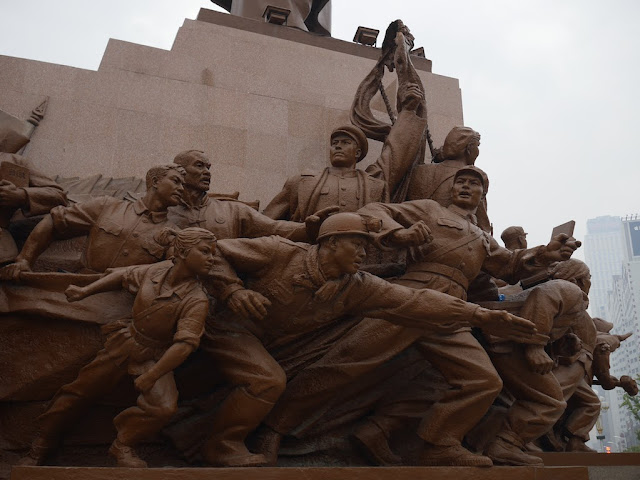 figures surrounding the Mao Zedong statue in Shenyang, China