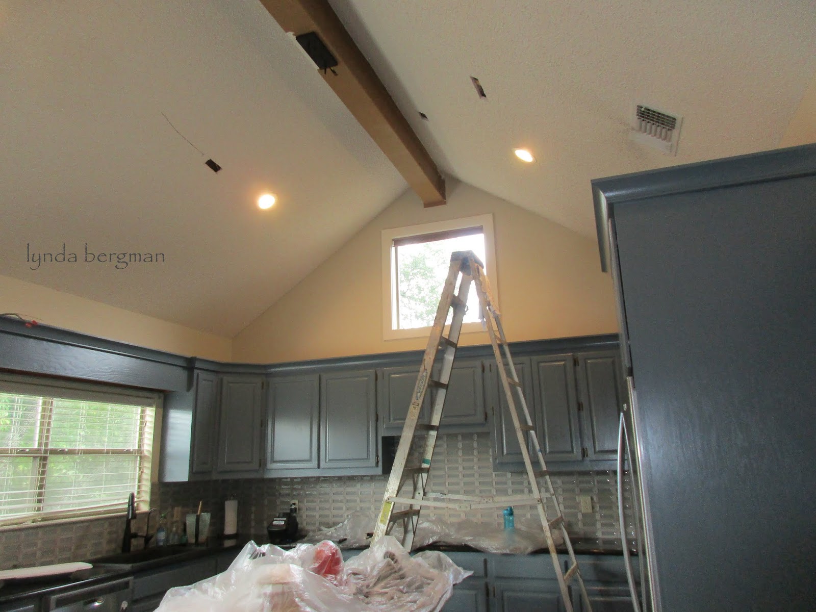 LYNDA BERGMAN DECORATIVE ARTISAN PAINTING A WHITE CEILING BEAM TO LOOK