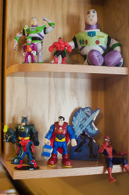 superheros on shelf