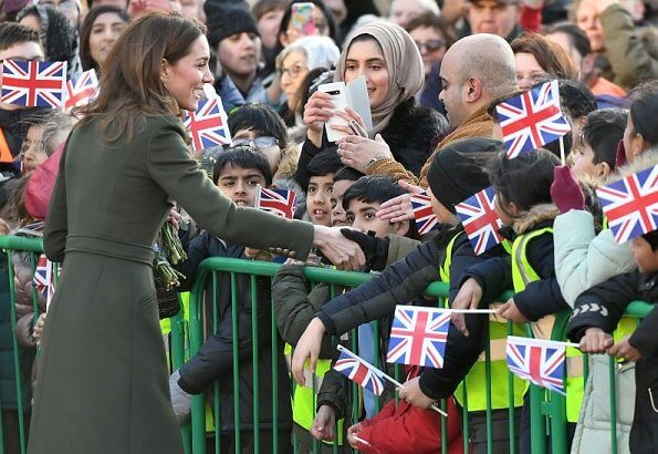 Kate Middleton wore a green Alexander McQueen coat, a print dress by Zara, Zeen ceramic earrings and Aspinal of London Mayfair bag