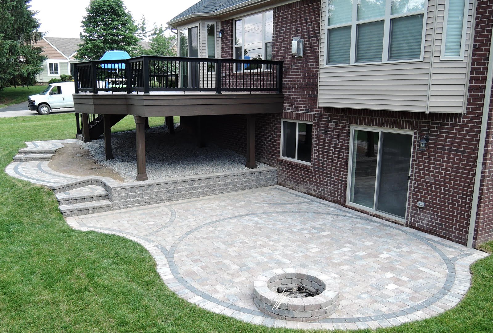 Outdoor Living Low sloped roof decks, composite pavers and cable rail.