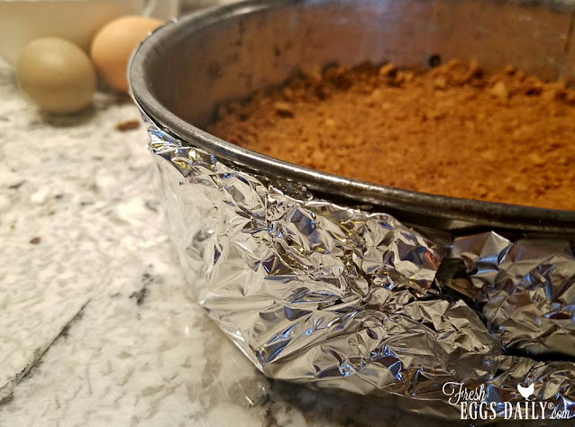 gingersnap cookie crust in foil-wrapped springform pan