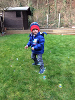 Little boy playing with bubbles in the garden