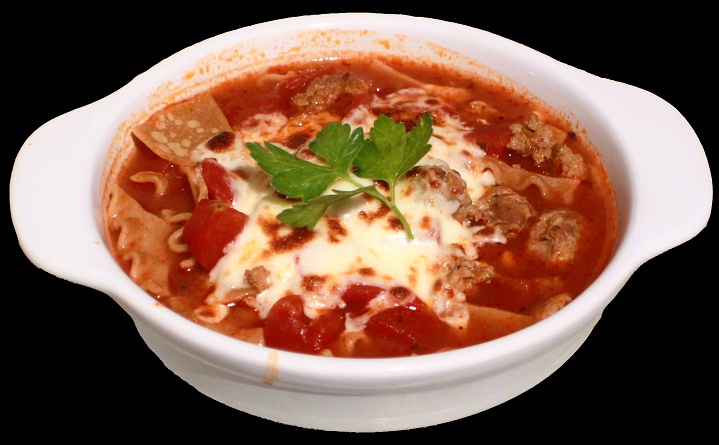 this is a recipe for lasagna soup poured in a white ceramic bowl with noodles, sauce and meats