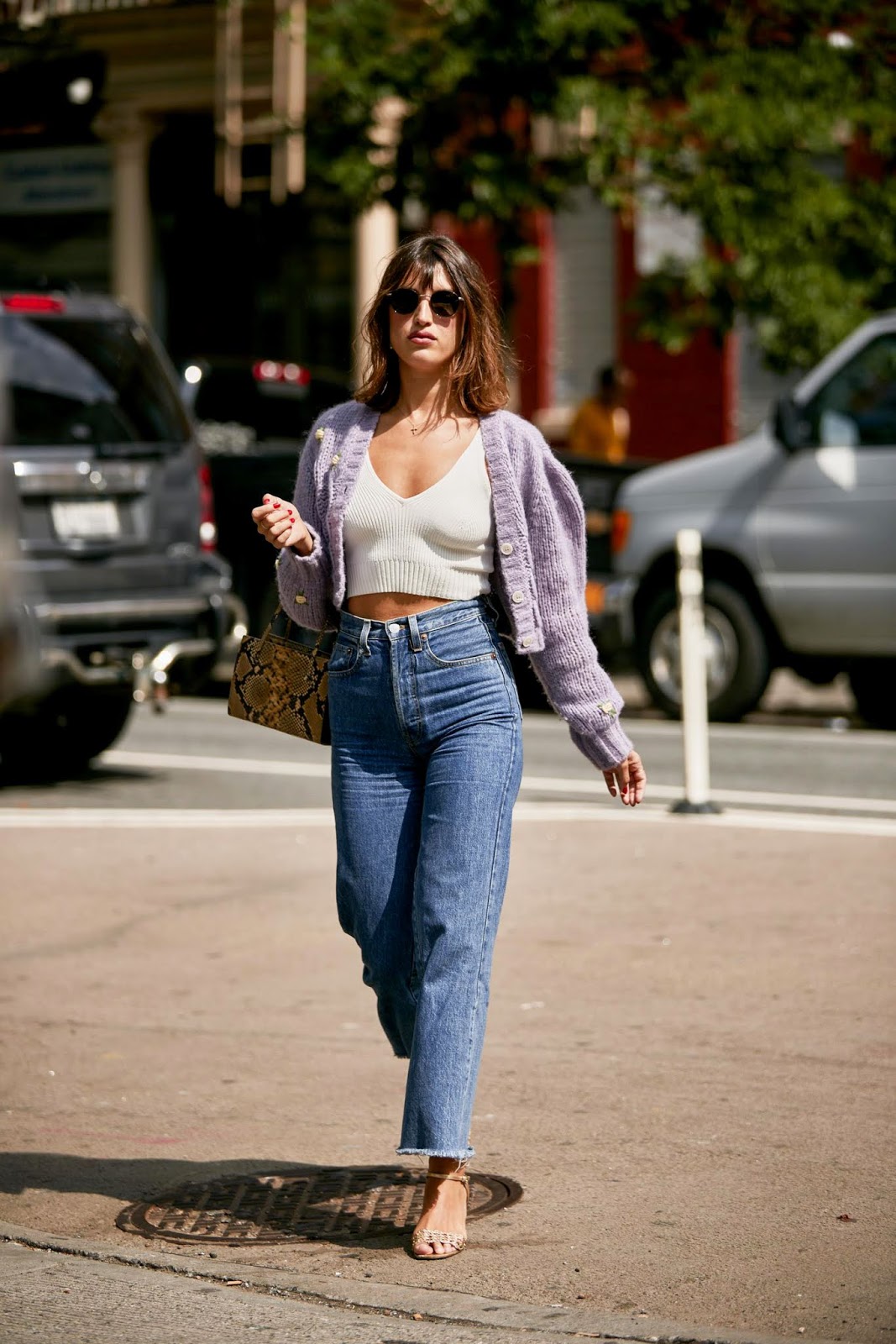 French-Girl Spring Style — Jeanne Damas in a purple cardigan, white tank top, snake-print bag, high-waisted jeans, and sandals 