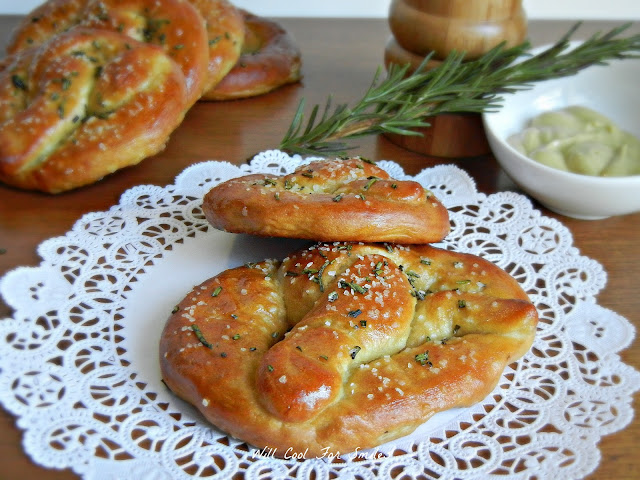 rosemary soft pretzels on a lace napkin on cutting board 