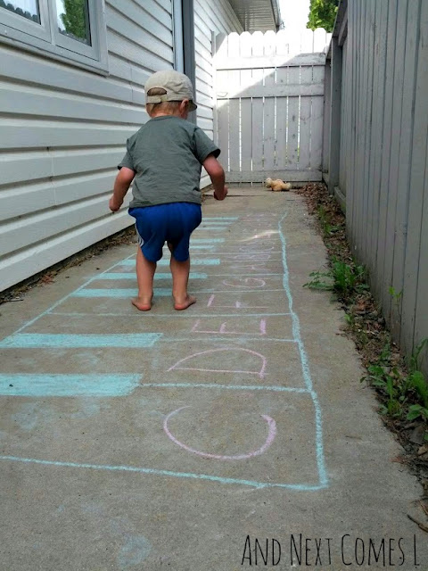 Child jumping on a musical fun keyboard outdoors