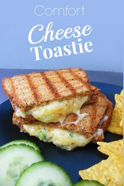 Oozy Comfort Cheese Toastie cut in half and stacked on black plate