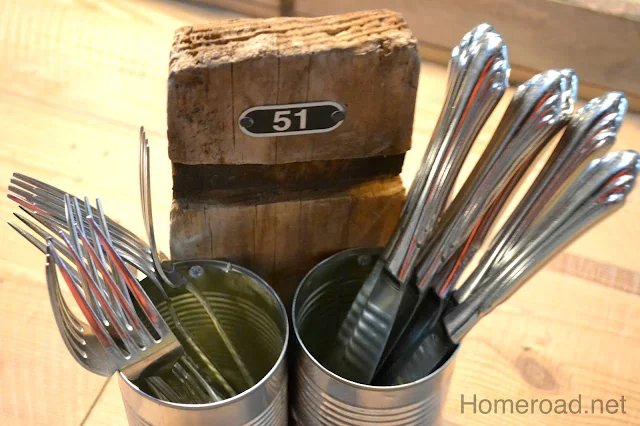 barrel piece with cans filled with silverware