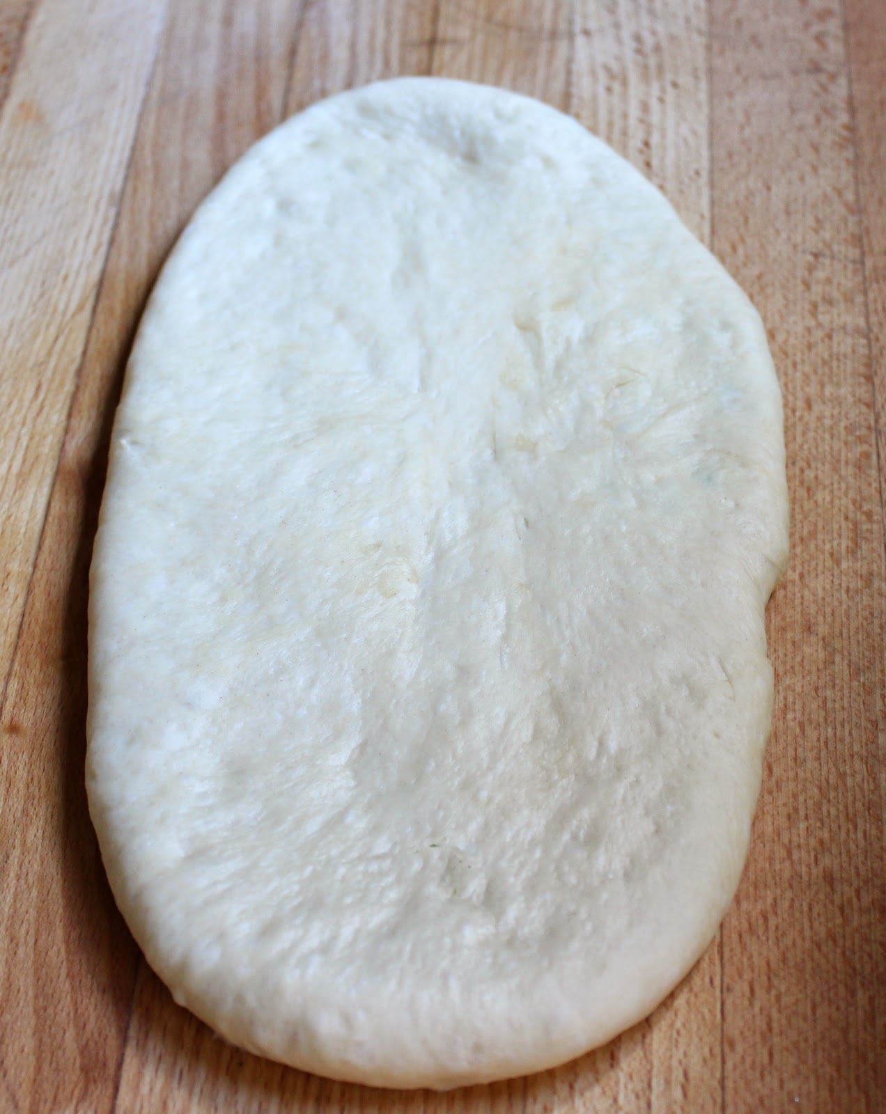 Stuffed naan dough rolled and ready for the oven 