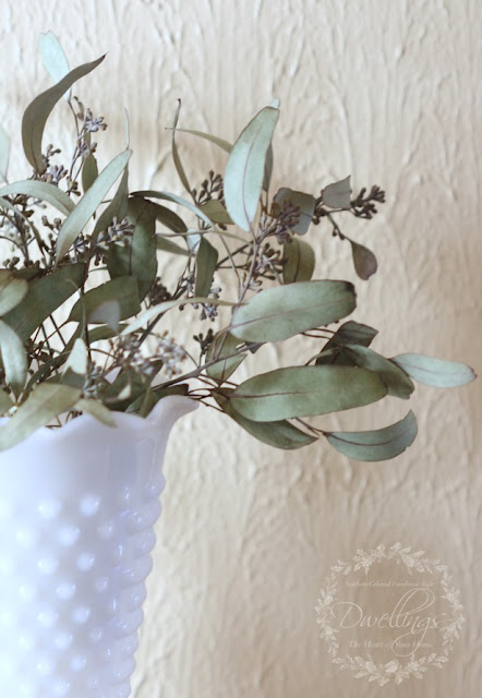 Dried seeded eucalyptus used in a floral arrangement.