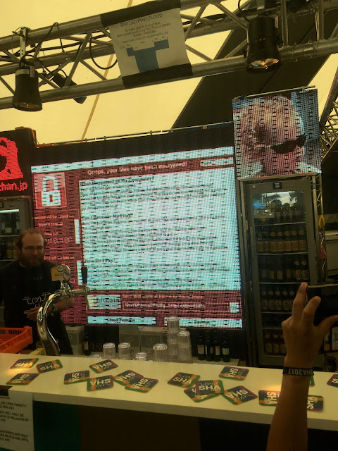 LED displays showing images and a cryptolocker ransom screen behind a bar