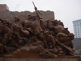 figures surrounding the Mao Zedong statue in Shenyang, China