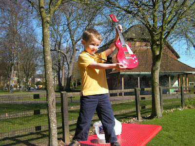 raising toy plastic guitar to the sunlight milton park portsmouth