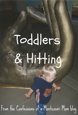 Lisa's son as a tot walking in front of a large bronze hand sculpture