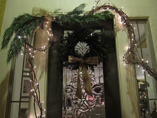 front door Christmas wreath with lighted grapevine