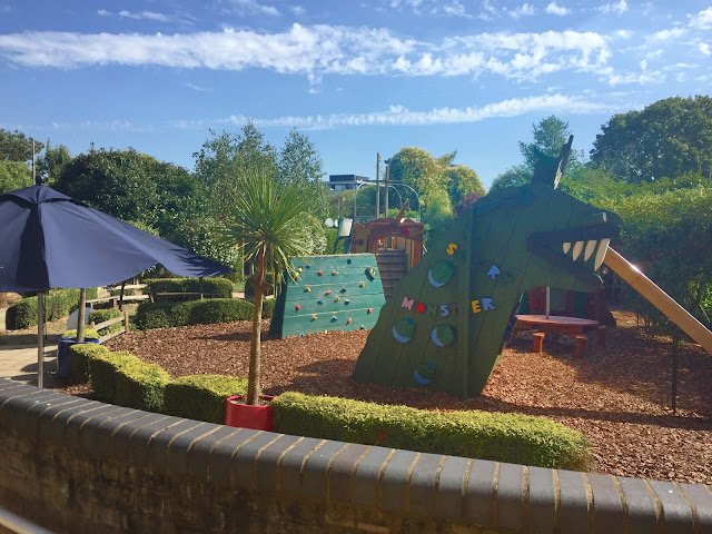 The Story Garden at Discover Children's Story Centre visible are a monster slide, climbing wall and pirate ship