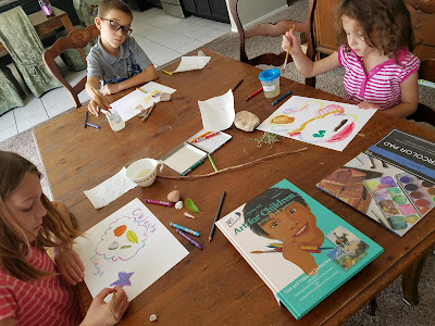 kids completing art projects from Artistic Pursuits
