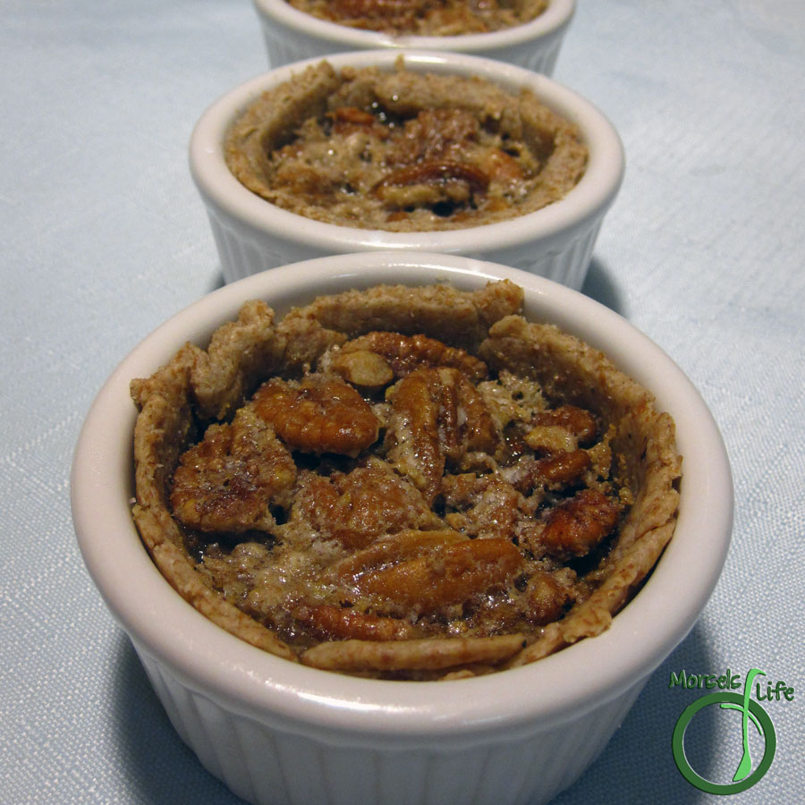 Morsels of Life - Mini Pecan Pies - Pecans nestled in a sweet brown sugar filling and surrounded by a crispy crust.
