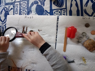 preschooler examining rust on objects