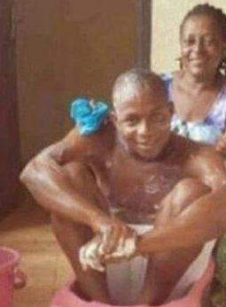 nigerian man bath by mother